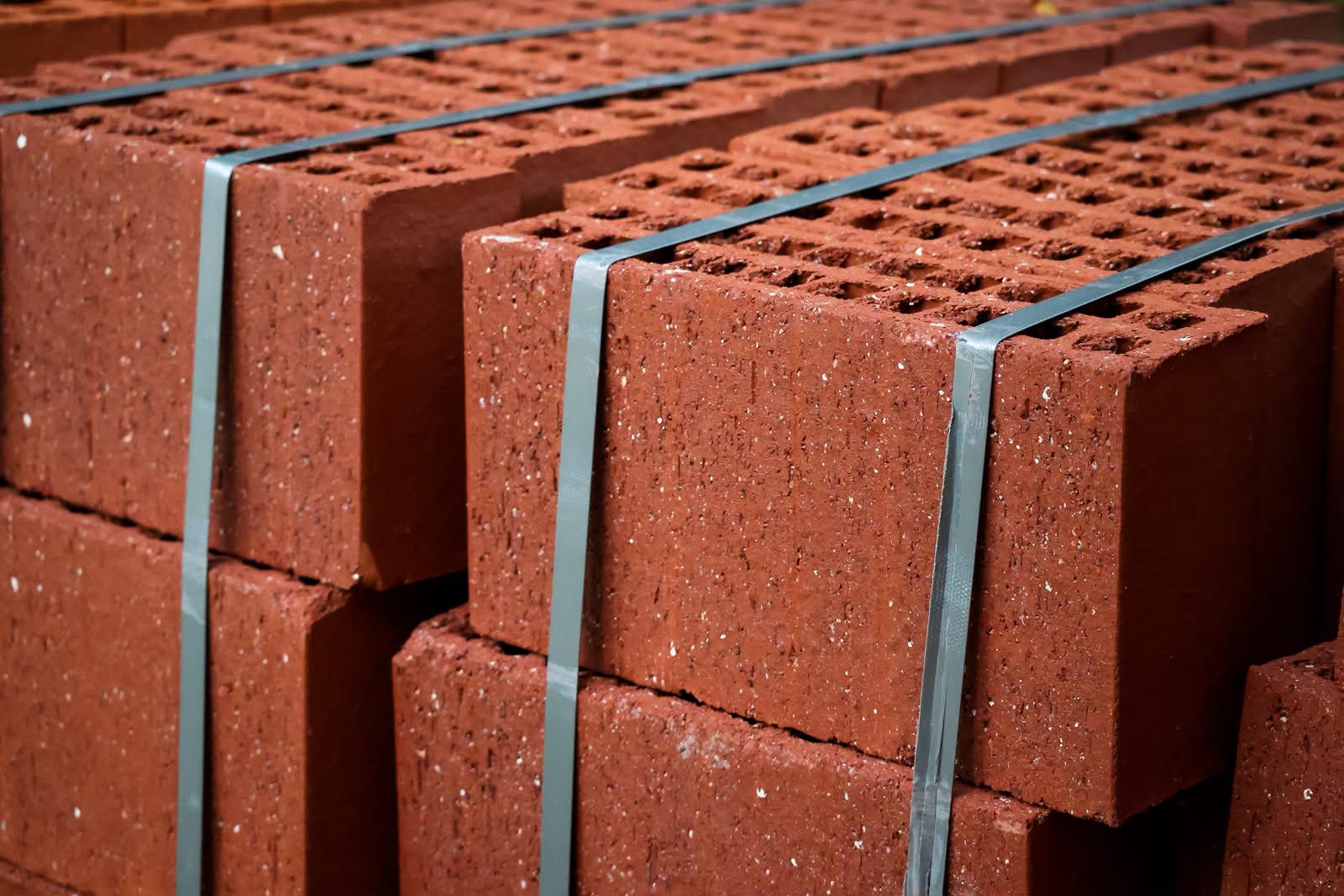 Side faces of stacked two-course bricks held with steel strapping